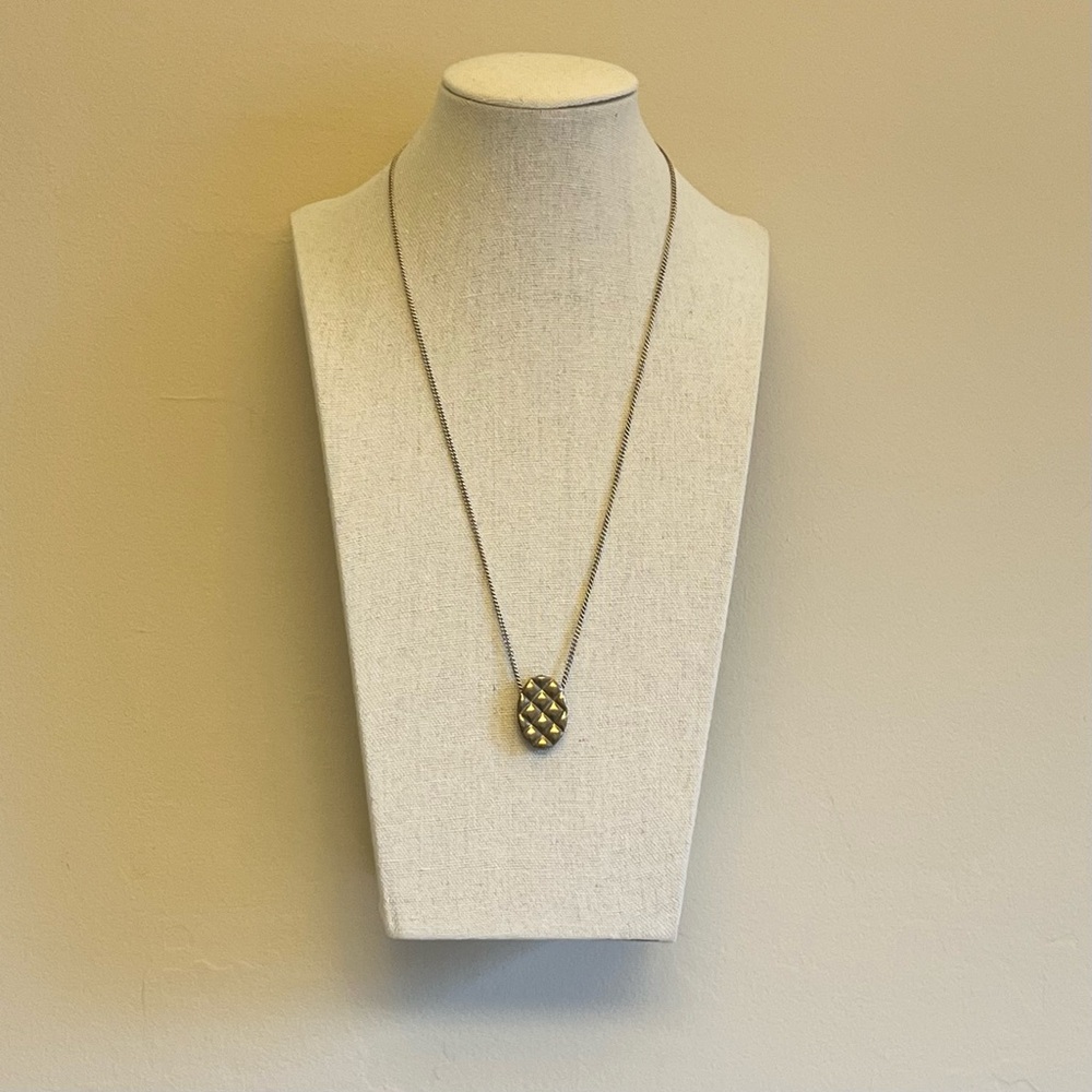 By AMT’s “Quilt” necklace in white brass